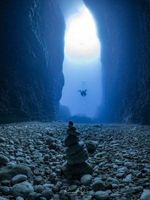 Der beeindruckende Canyon, der von dem Inland Sea auf Gozo in das offene Meer mündet. Ein kleiner Turm aus Steinen wurde von einem anderen Taucher aufgeschichtet